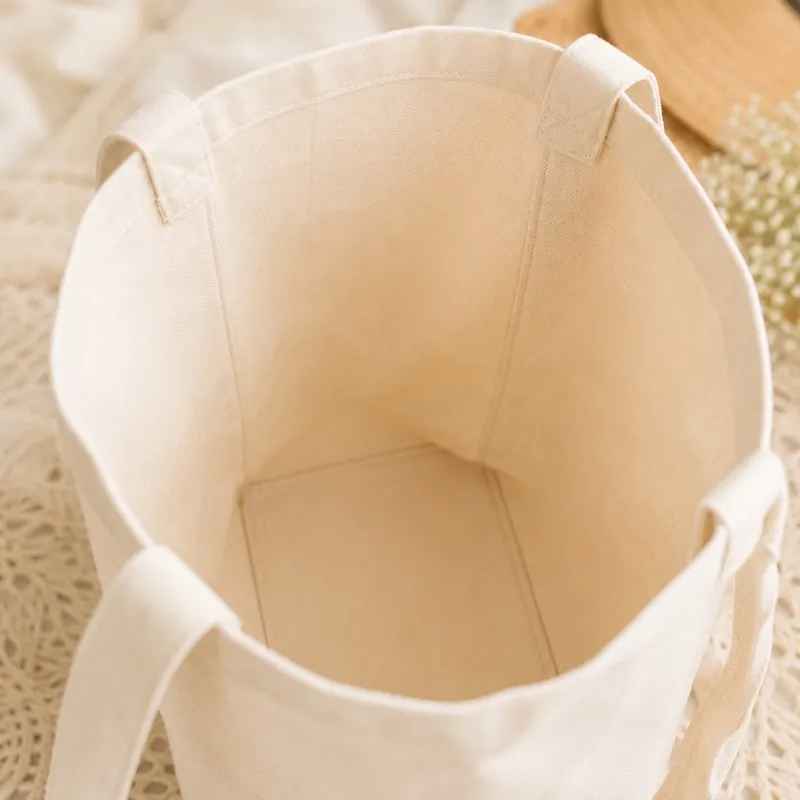 Looking into the open tote — unlined cotton canvas with reinforced handles